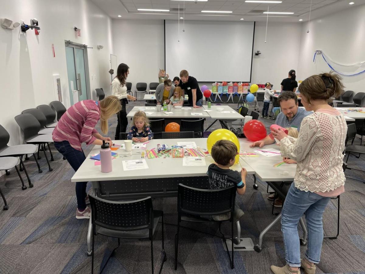 adults and children participating in science experiments and activities