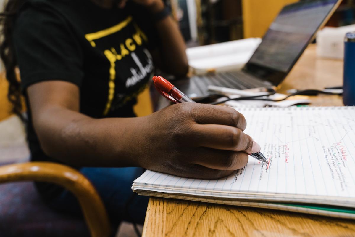 Student taking notes in a class.