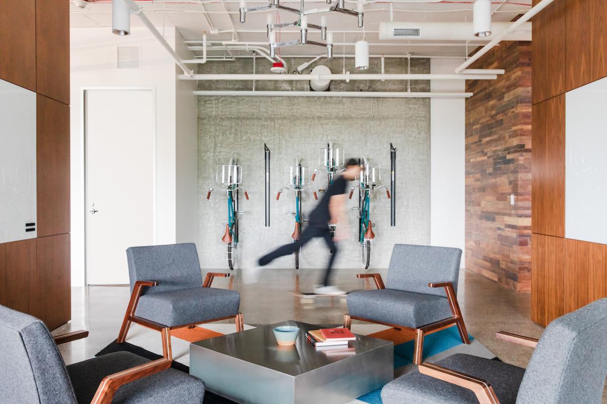 A person on a skateboard in the GoDaddy offices.