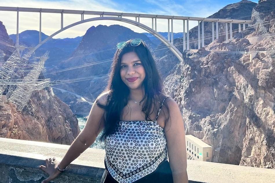 Sathvika in front of a gorge with a bridge in the background.