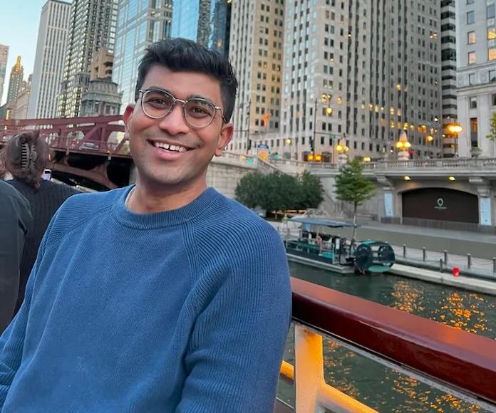 Adiyta Vikram in front of a river with a city in the background.