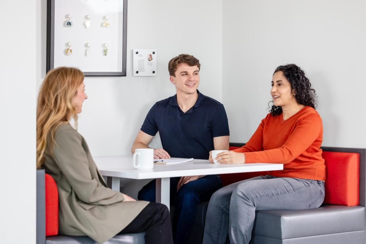 Three people seated at a table.