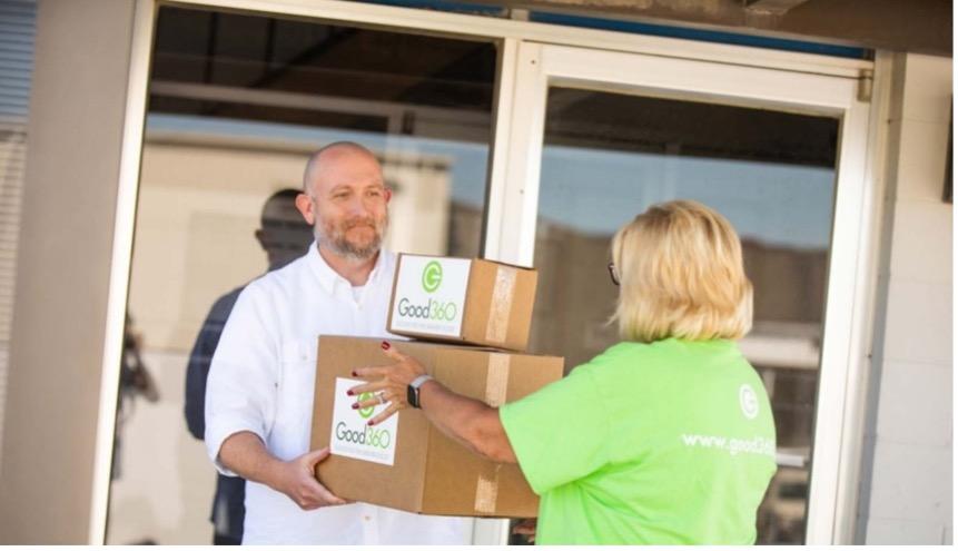 Person handing another person two boxes