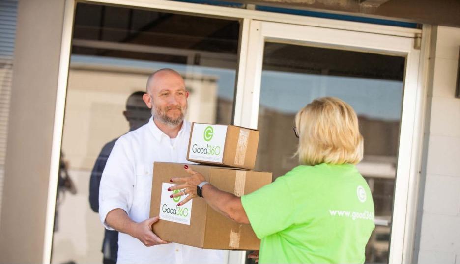 Volunteer handing off boxes