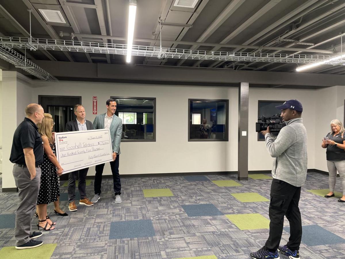 KeyBank and Goodwill team members holding the grant check.