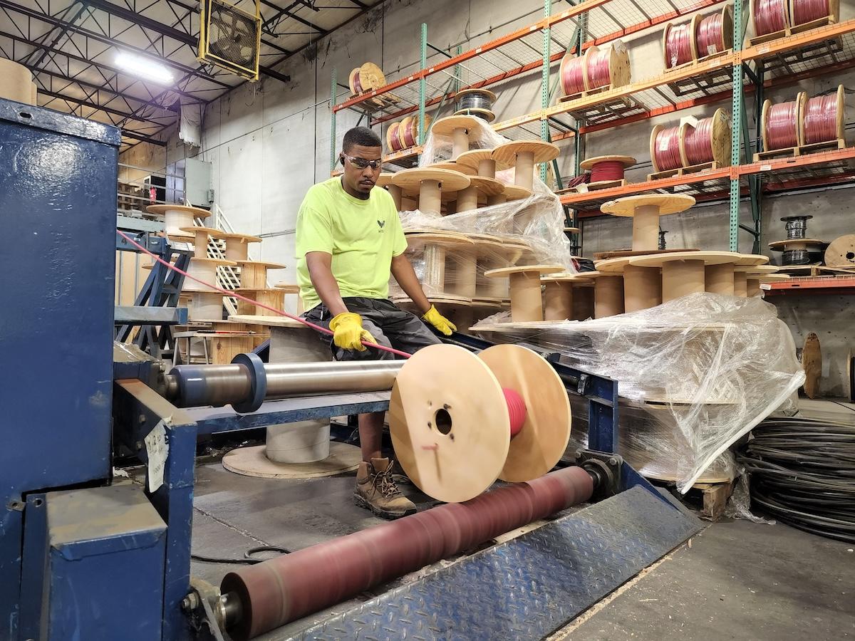 Wesco employee cutting wire.