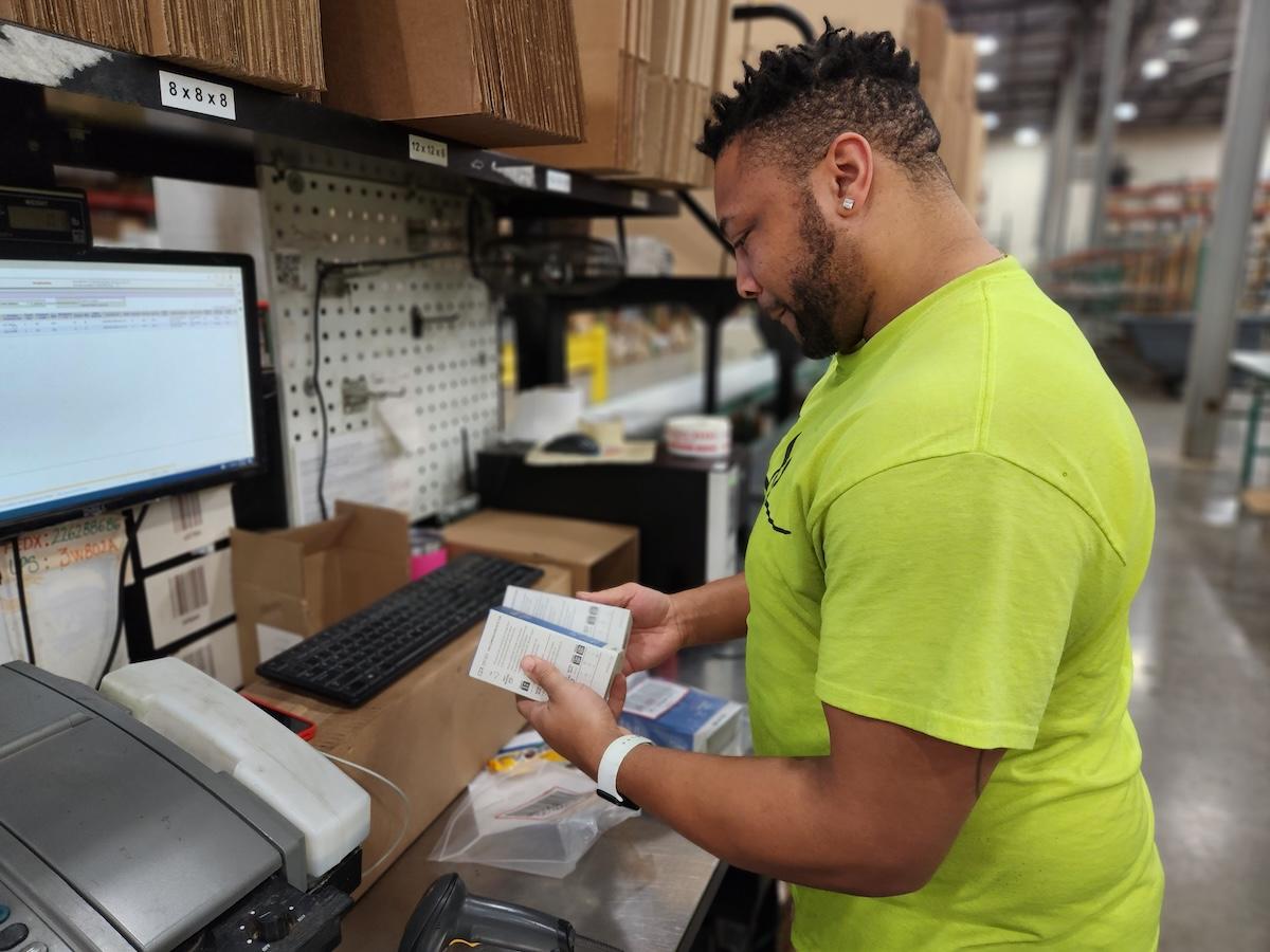 Wesco employee packing items for shipment.