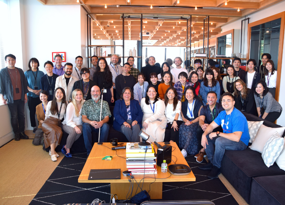 A large group photo of people in an office