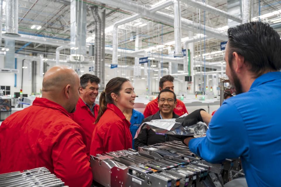 HARMAN team members shown in a factory.