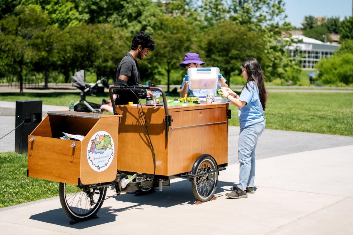 Group of people around a wooden cart