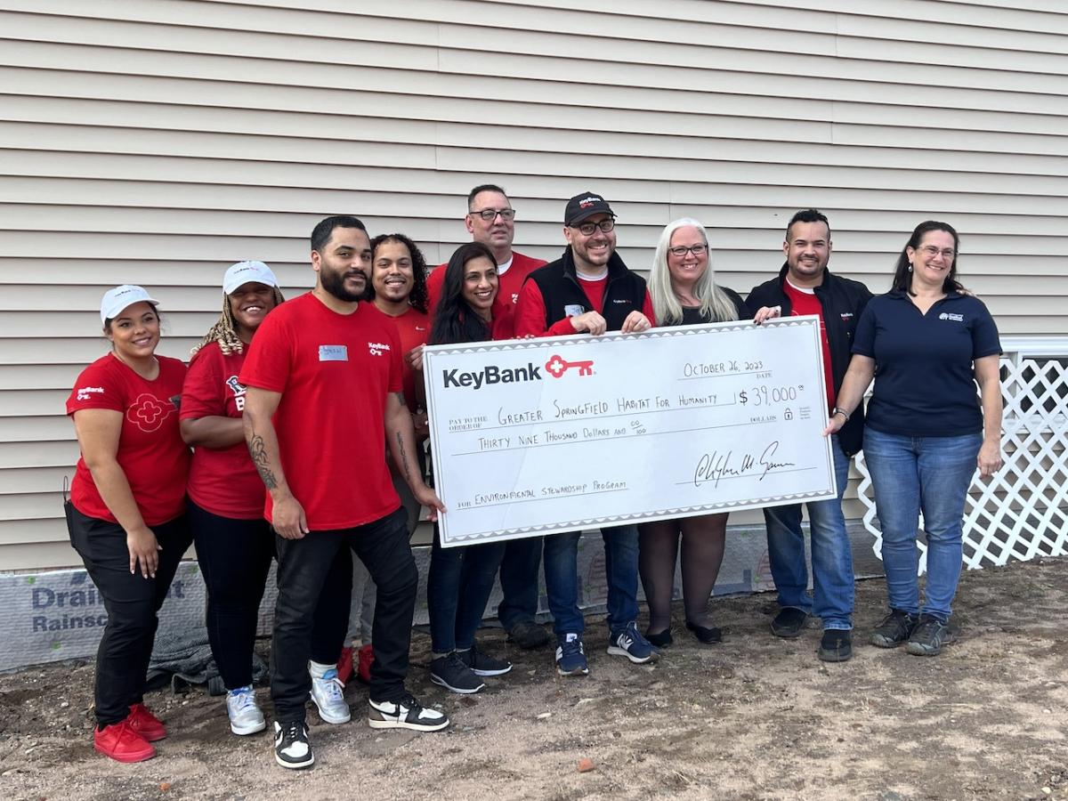 Photo: (from left) KeyBank branch employees Janis Deynes, Sharia Coley, Josh Flores, Norbert Grant III, Priya Tater, Tom Morace, Jeff Guyott,  Kendle Taylor, and Holyoke Branch Manager Tito Ramon who presented the grant check to Habitat for Humanity’s Executive Director Aimee Giroux (far left). 