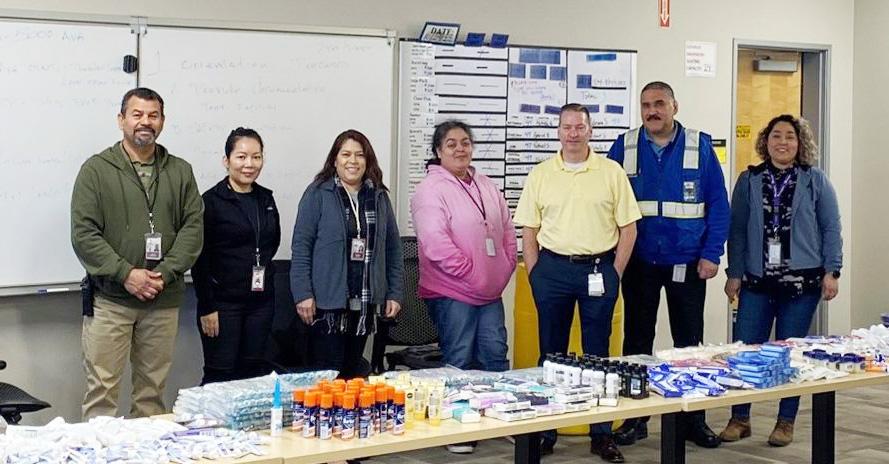 Group of teachers in the United States in front of a table. 