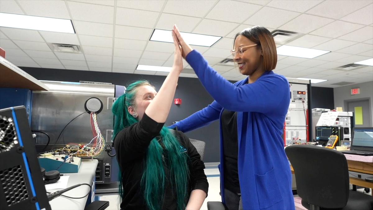 HARMAN Engineer Kelly giving a high-five.