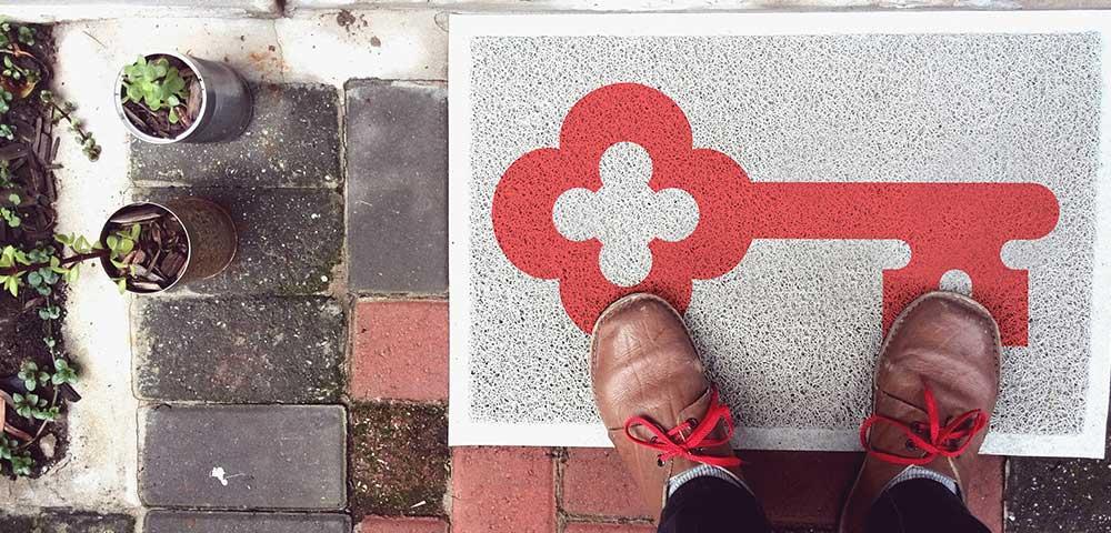 keyBank home lending logo. Keybank logo on the doormat in front of a home.