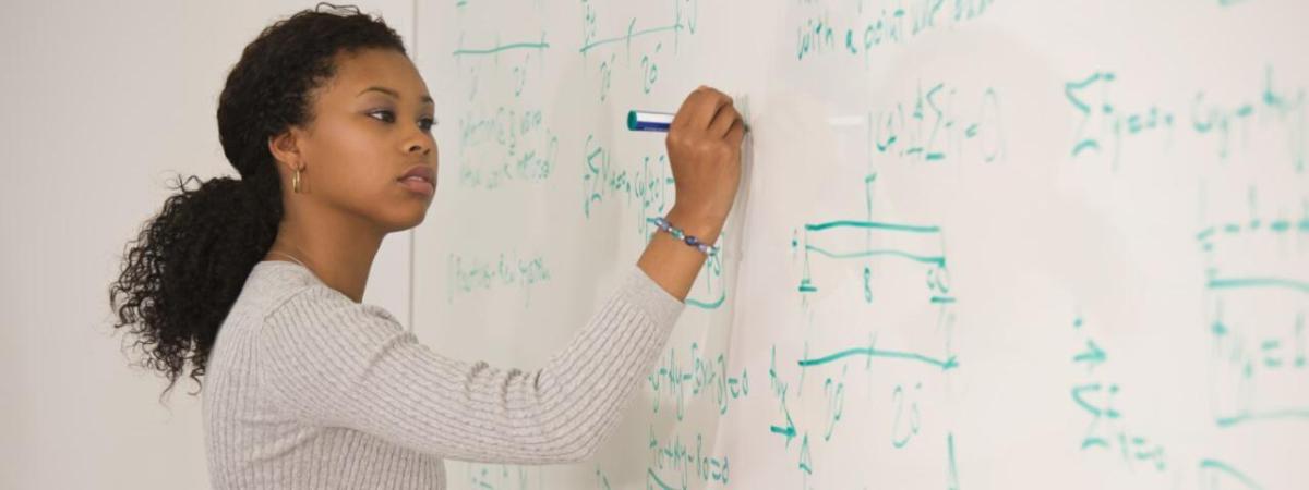 woman writing on a whiteboard