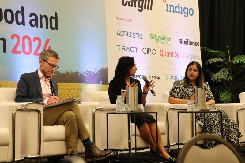 Nivera Wallani and Nira Johri seated on a stage with another.