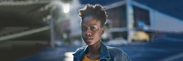 Black woman in an urban landscape at twilight