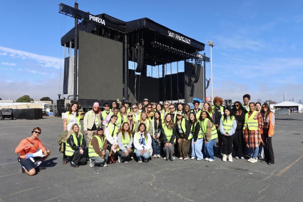 Students posed for a photo in front of the festival's main stage while on their exclusive festival grounds tour.