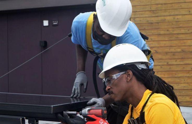 Workers installing solar panels.