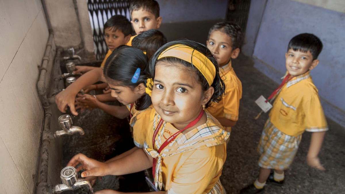 Children washing their hands.