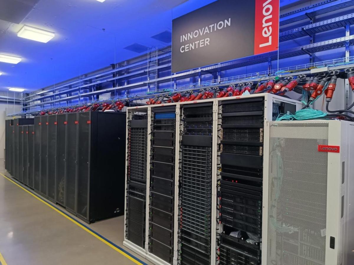 Row of tall servers and tech devices. A lenovo Innovation Center banner overhead.