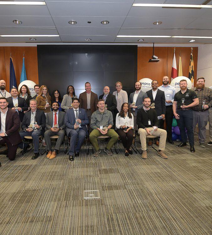 Large group photo of people holding an award