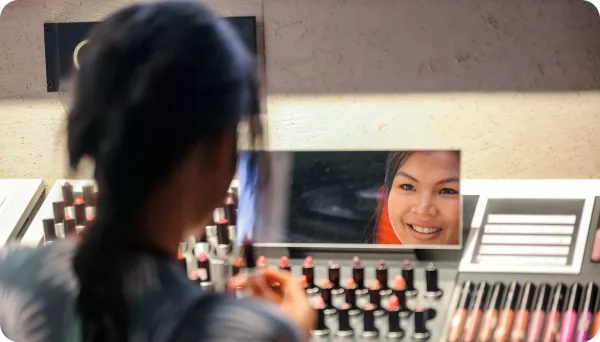 Person applying makeup in a mirror