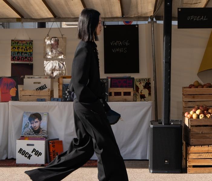 Model shown wearing a black pantsuit in Stella McCartney's Sustainable Market.