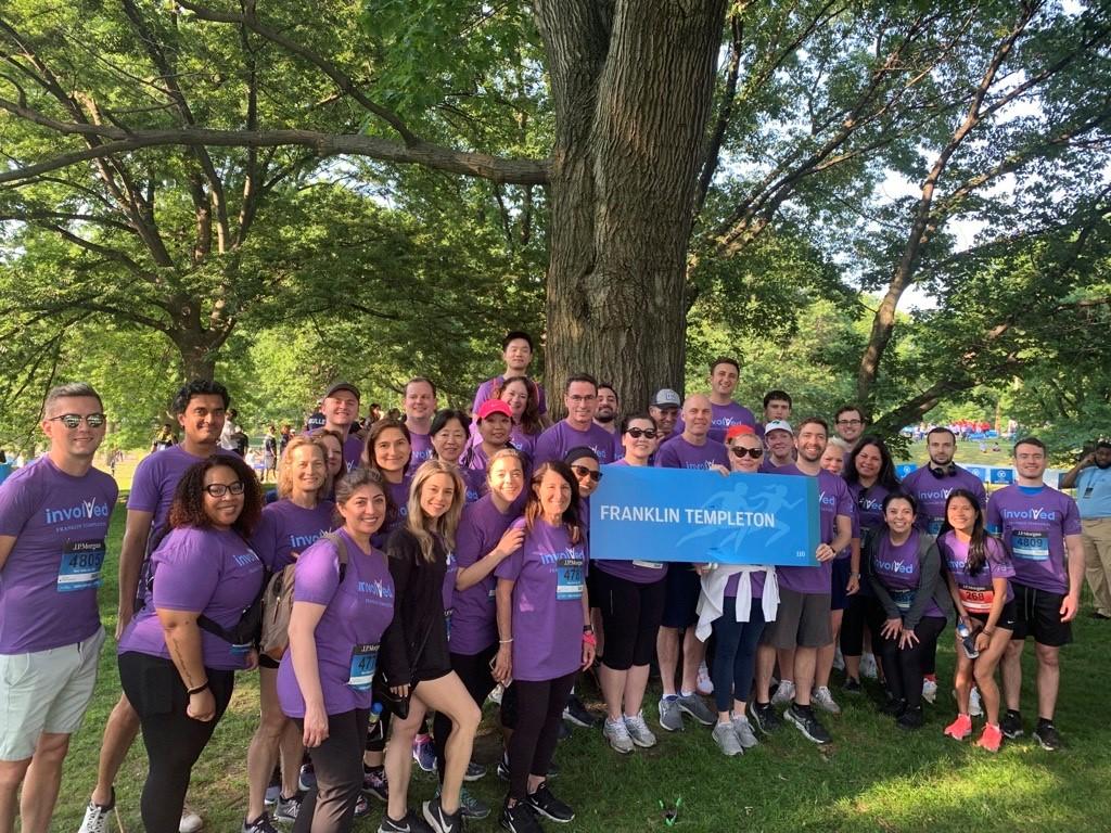 NYC volunteers standing outside under a tree