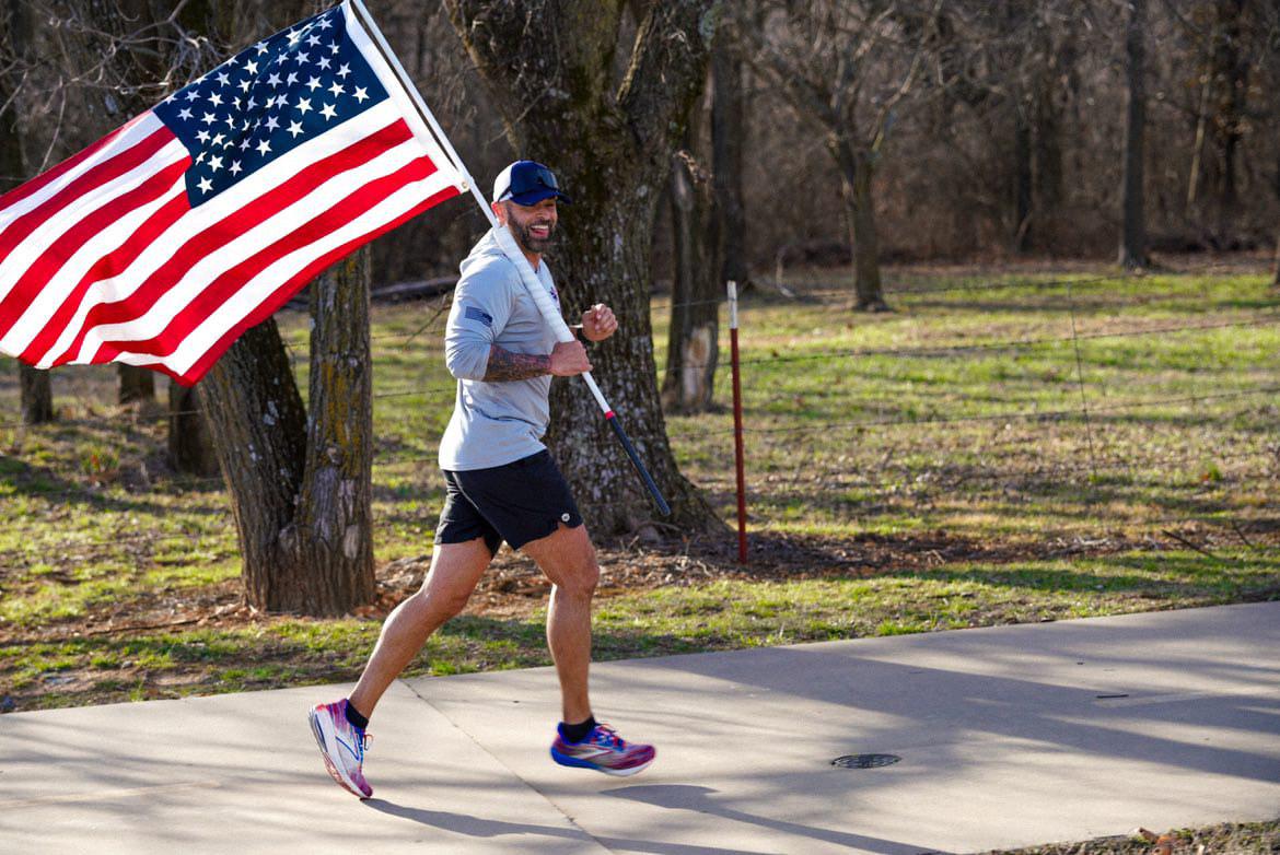 Jason Wood running with flag