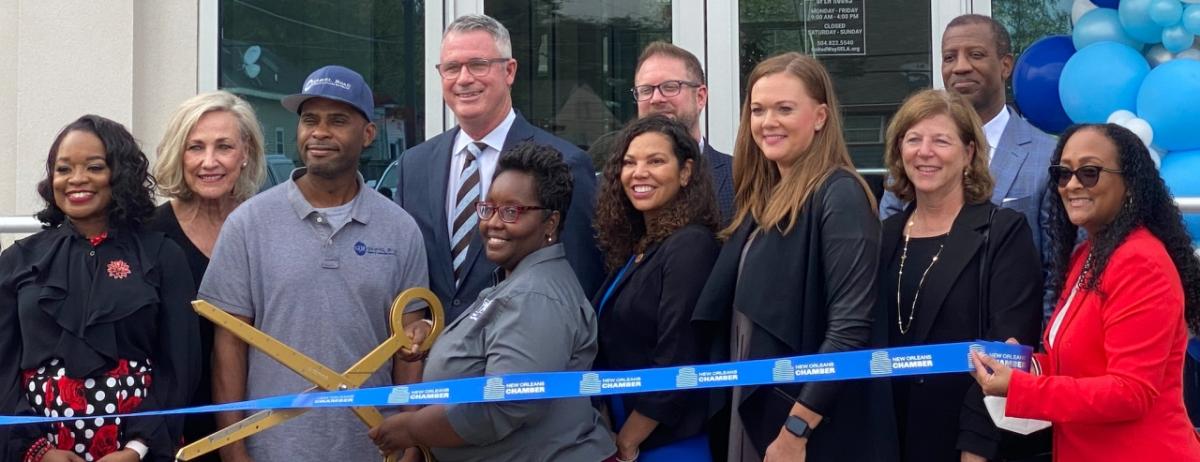 group performing ribbon cutting 