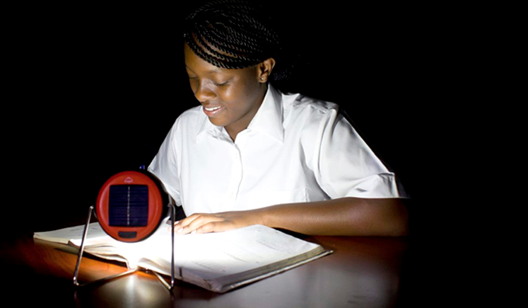 Person reading in the dark with small light