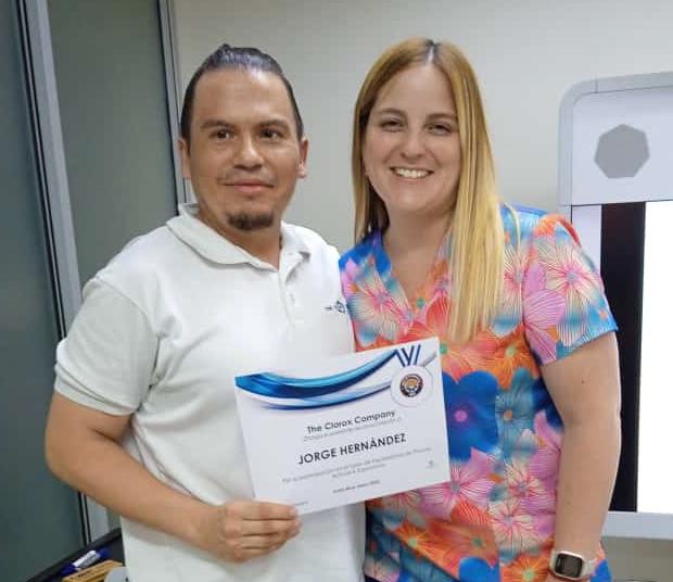 Jorge holding an award next to another person.