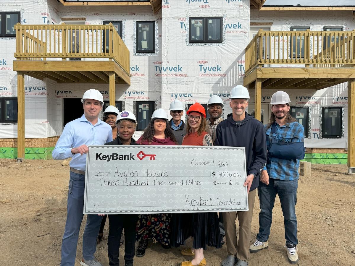 KeyBank and Avalon Housing representatives shown with a $300,000 grant check.