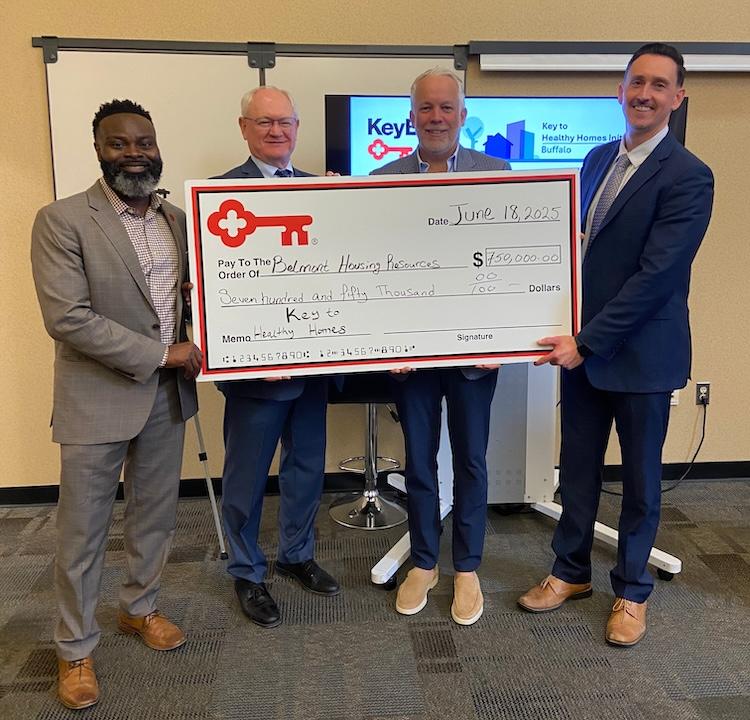 Representatives from KeyBank and Belmont Housing Resources shown with a $750,000 grant check.