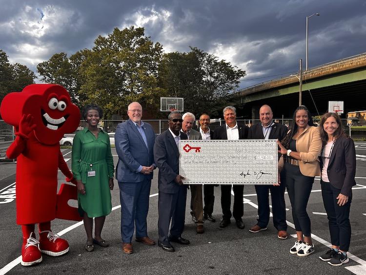 Representatives from KeyBank and Excelsior University shown with a check.