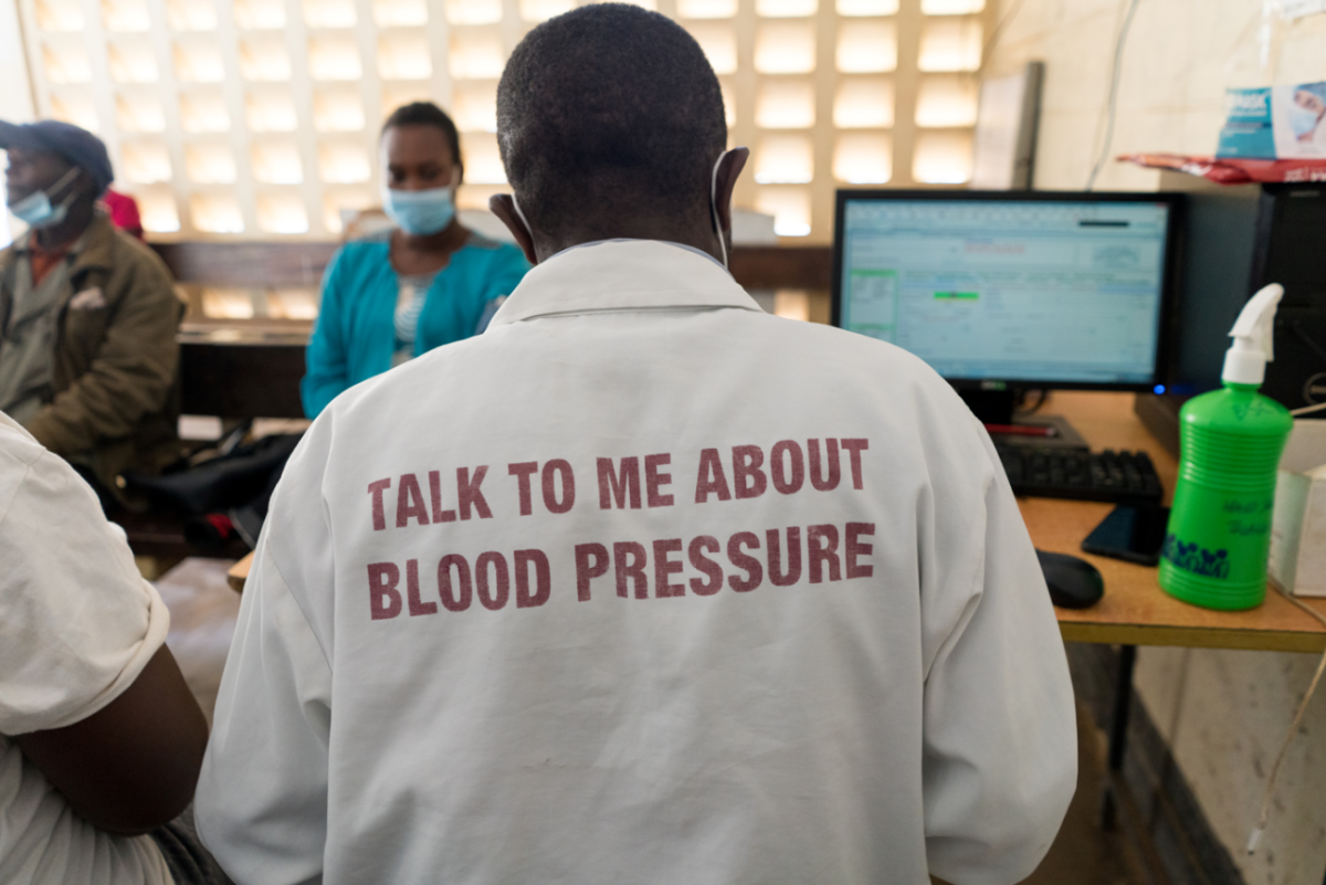 Person with a shirt that reads "Talk to me about blood pressure" 