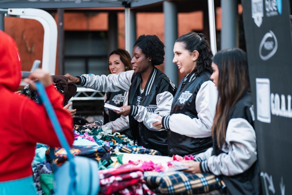 LA Kings staff distributing blankets under a tent