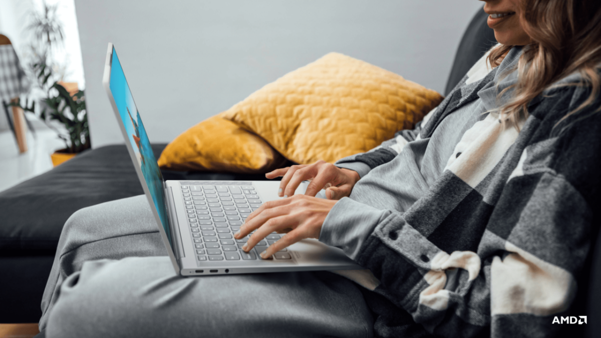 person in a home setting typing on a laptop