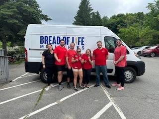 Bread of Life van and KeyBank volunteers shown.