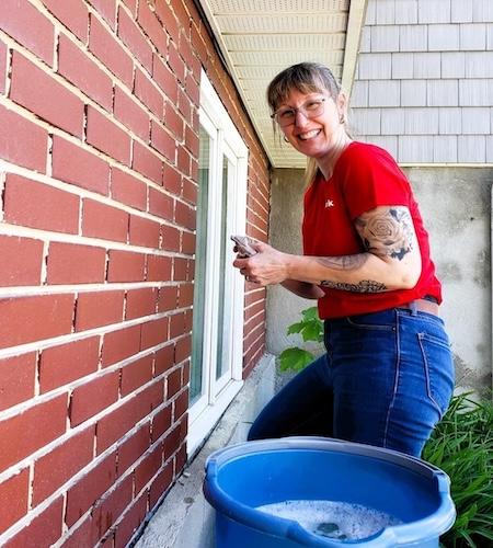 KeyBank volunteer shown cleaning windows.