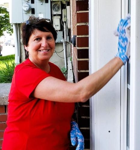 KeyBank volunteer washing windows.