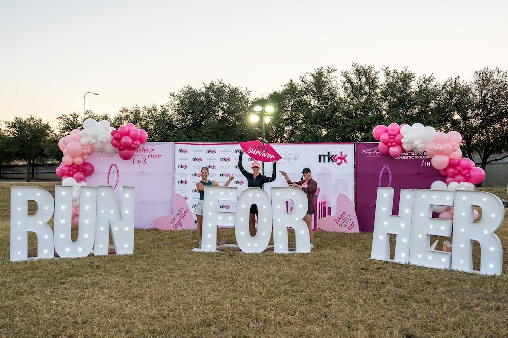 Sign reading "RUN FOR HER"