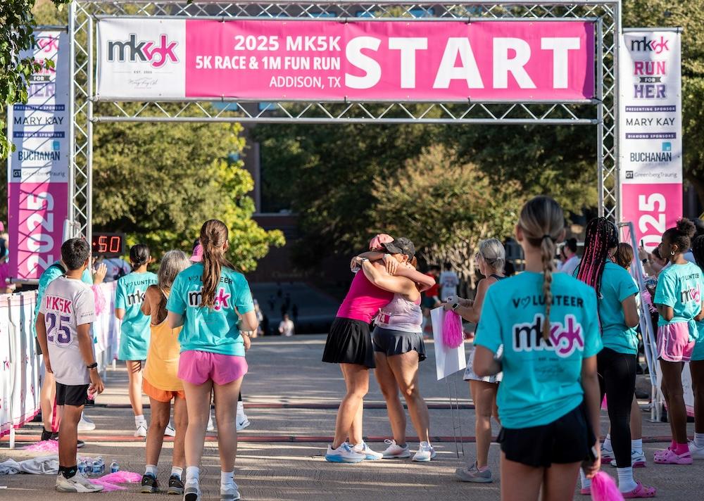 Smiles and a warm embrace at the finish line of the 2025 MK5K where community spirit and generosity come together to make a lasting difference for women across the country. (Photo Courtesy: Paul Vela)