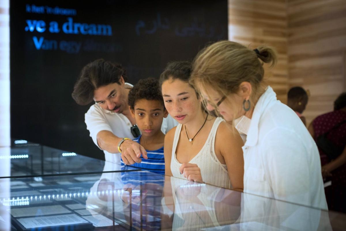 4 people looking at exhibit