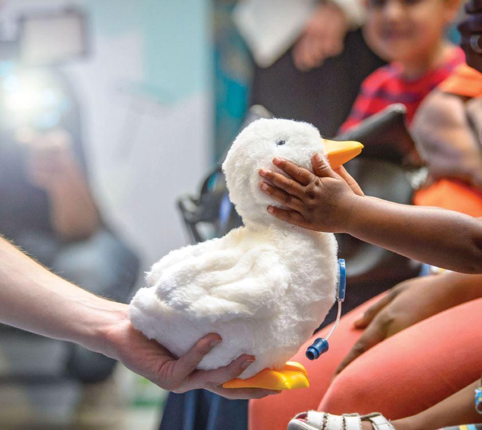 My Special Aflac Duck shown with children.