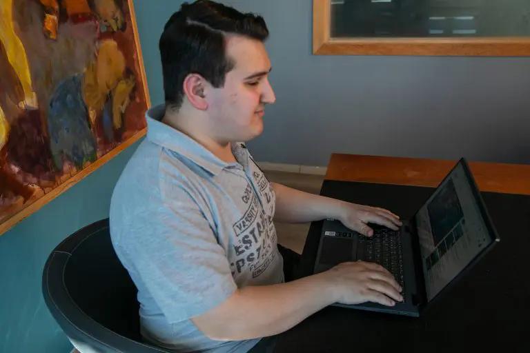 visually impaired person with their palms resting on a BlindLook laptop