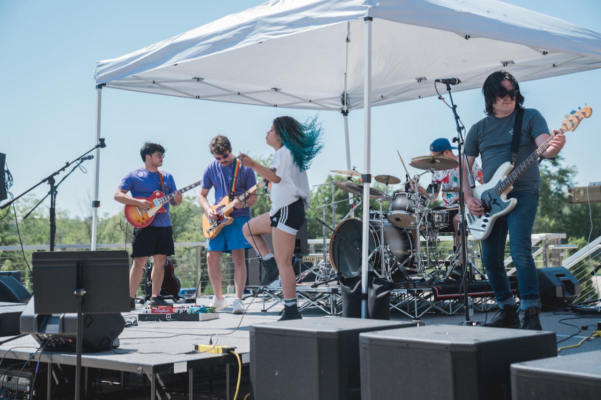 HARMAN employee band; female singer is jumping on the stage.