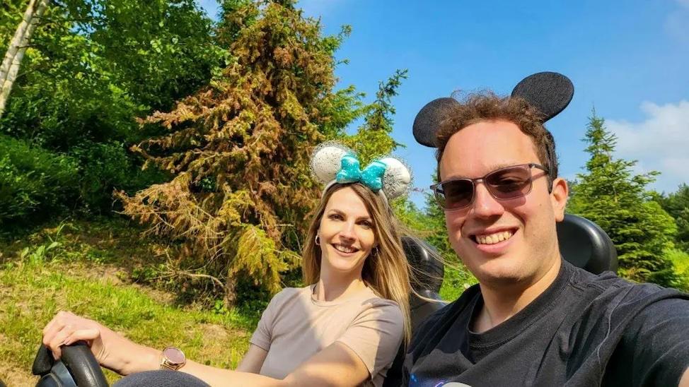 Marija Petrovic shown with her husband on a drive wearing Mickey Mouse ears.