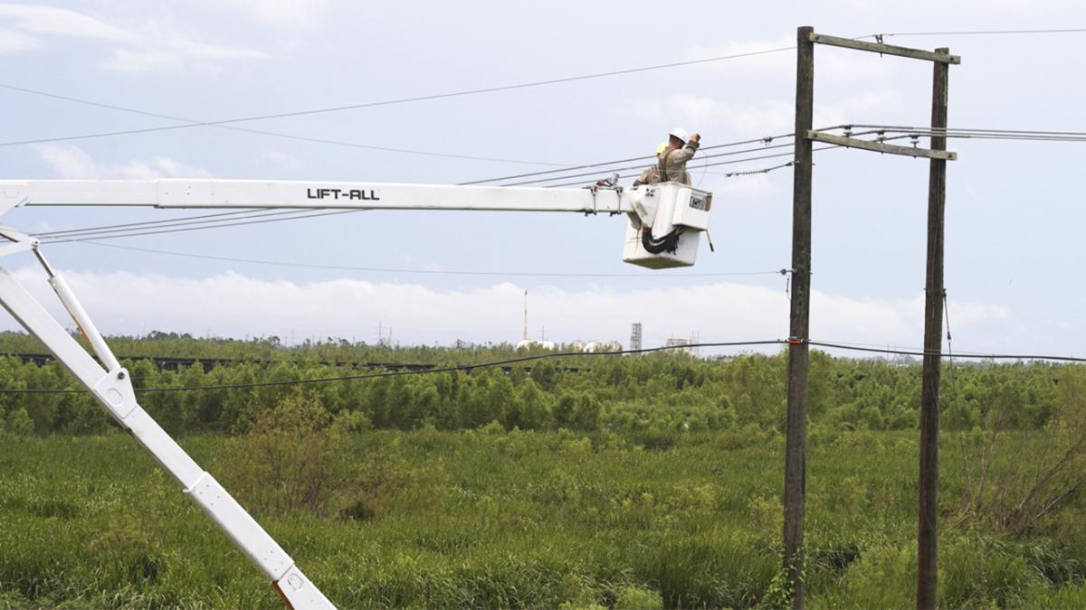 person working on utility pole